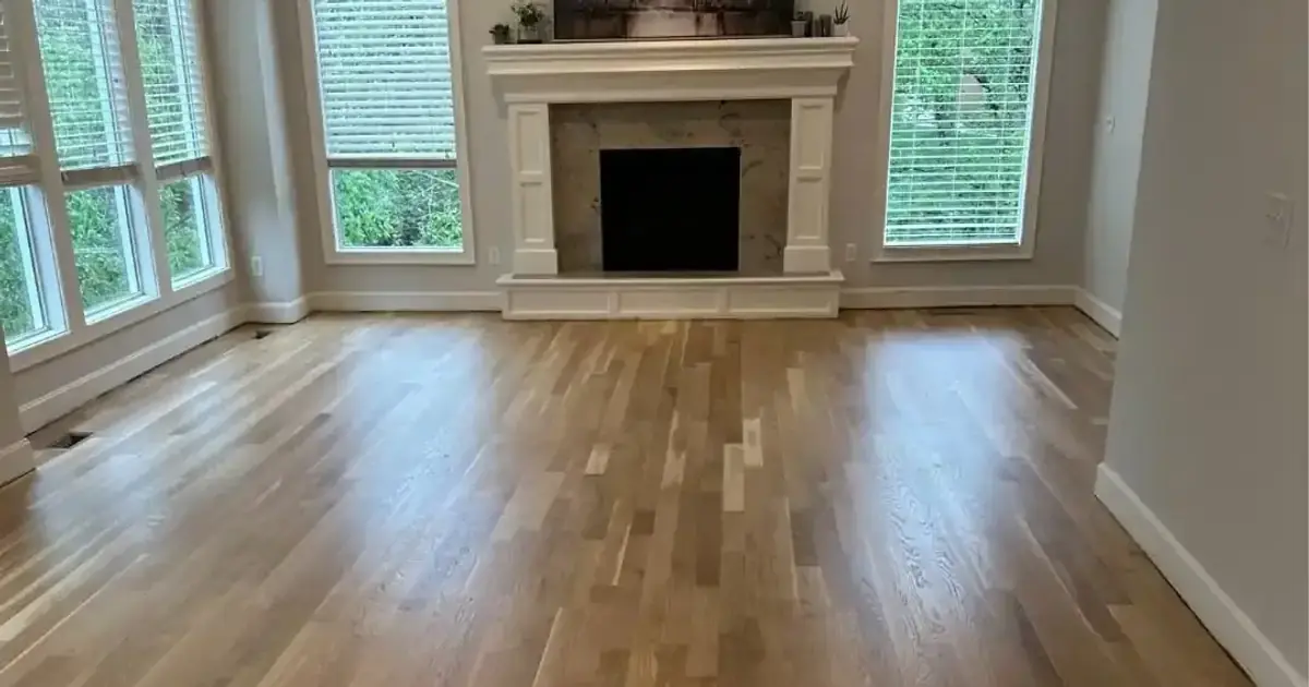 Clean, freshly finished oak floor catching daylight in a Kansas City living room, the kind of intact polyurethane surface that routine dry cleaning and a pH neutral cleaner keep looking new